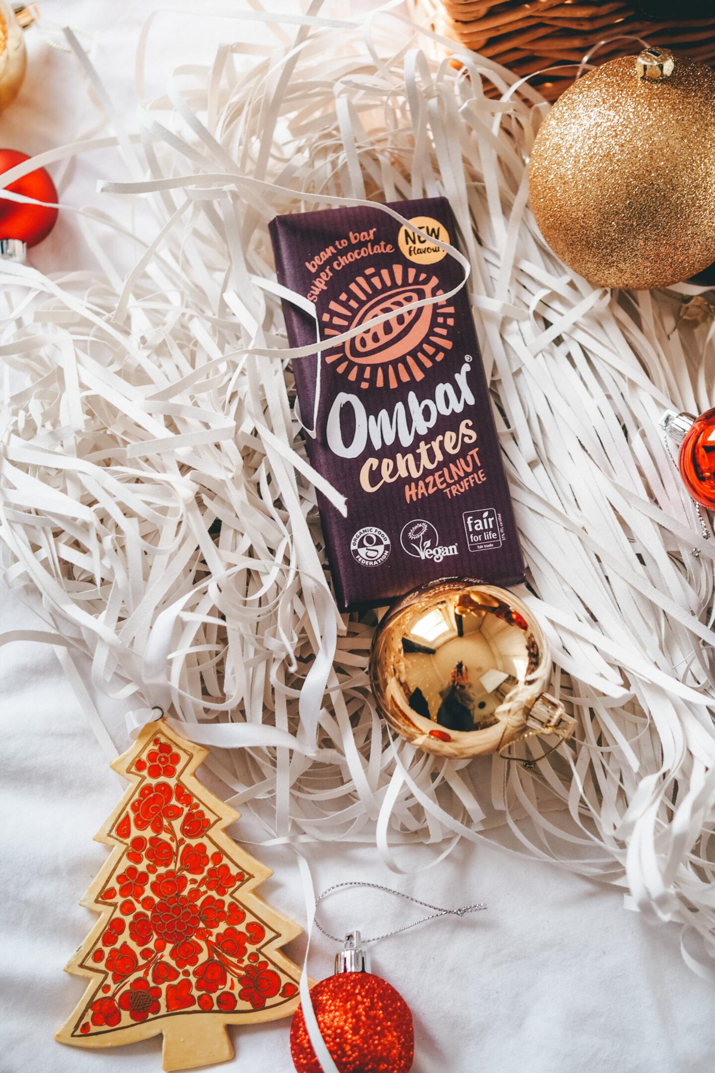 Ombar Centres Hazelnut Truffle chocolate bar surrounded by baubles | Sustainable Stocking Fillers under £15