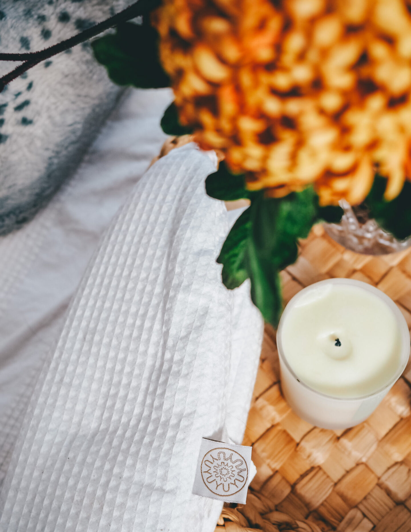Close up of YuYu bottle with INTUI candle and pop up bloom flowers | The Chronically Living Gift Guide